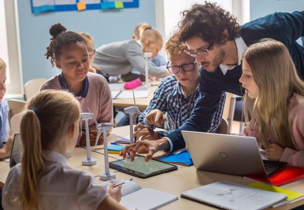 Teacher teaching kids on laptop