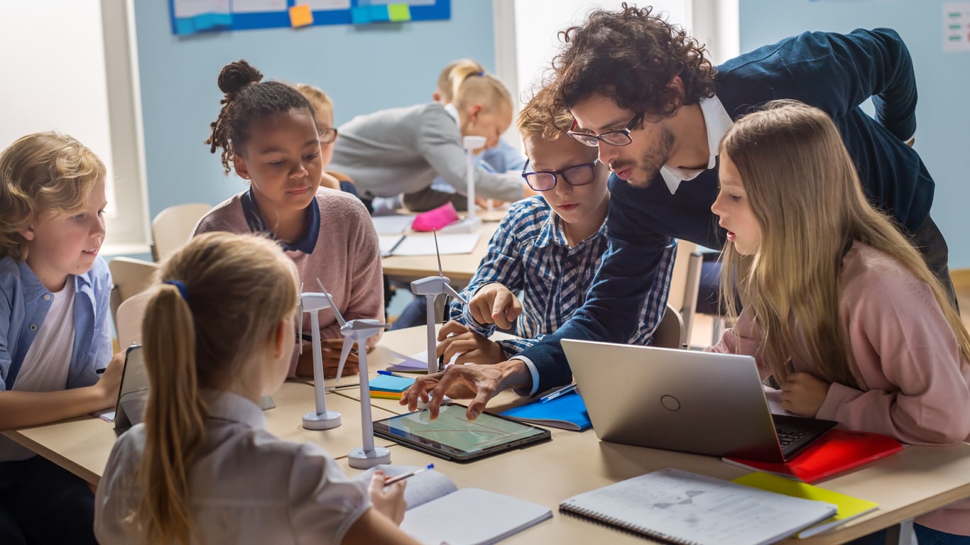 Teacher teaching kids on laptop